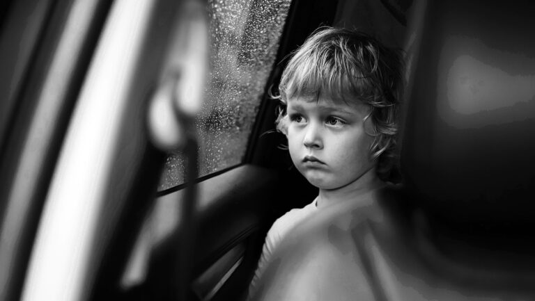 small child looking out car window