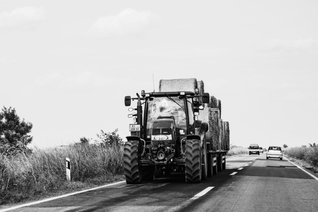 tractor or other farm vehicle on the road hauling hay